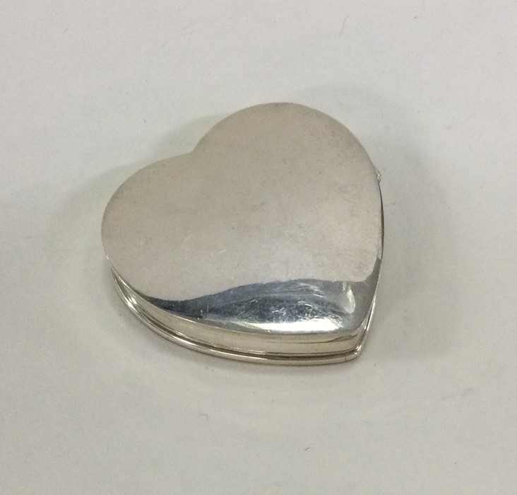 A heart shaped silver hinged top pill box. London.