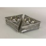 A pair of Victorian cast silver salts of triangula