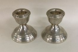 A pair of circular silver piano candlesticks. Birm