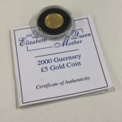 A Queen Elizabeth II Guernsey Proof gold £5 coin.