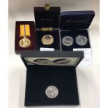 A group of four cased Proof commemorative coins to