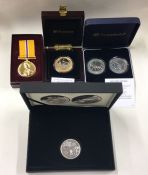 A group of four cased Proof commemorative coins to