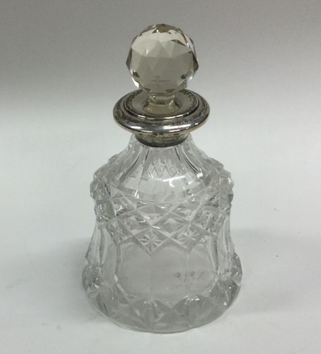 A silver mounted scent bottle with lift-out stoppe