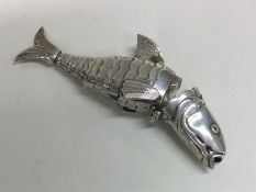 A large cast figure of a fish with articulated bod