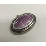 A small silver and enamelled compact with hinged t