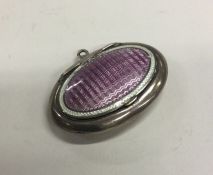 A small silver and enamelled compact with hinged t