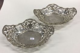 A fine pair of pierced silver dishes decorated wit