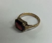 A garnet single stone ring in claw mount. Approx.