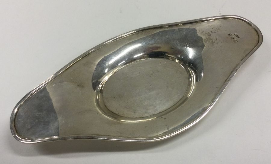 A silver oval dish attractively decorated with bea