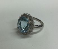 A large aquamarine and diamond oval cluster ring i