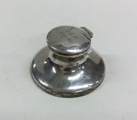 A circular silver capstan shaped inkwell. Birmingh