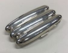 An unusual silver three finger cigar case with gil