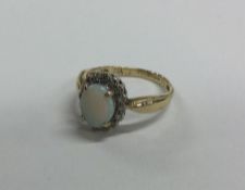 A 9 carat opal and diamond cluster ring in claw mo