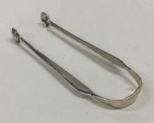 A pair of unusual silver sugar tongs with beaded e