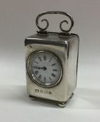 A good small silver carriage clock with white enam