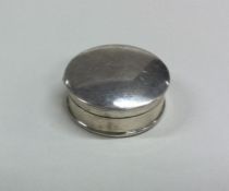 A circular silver hinged top pill box. London. By