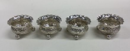 A good set of four embossed silver salts on ball f