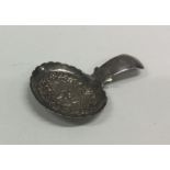An unusual silver caddy spoon decorated with figur