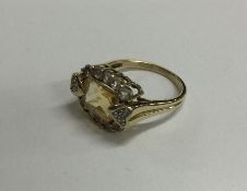 A 9 carat yellow stone ring in claw mount. Approx.