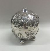 An unusual silver string box with embossed flowers