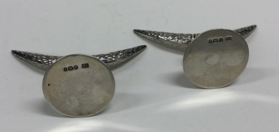 A pair of heavy cast silver knife rests in the for - Image 2 of 2