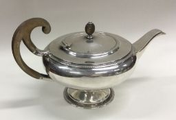 An attractive Edwardian silver teapot of stylised