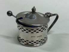 An Edwardian silver mustard pot together with matc