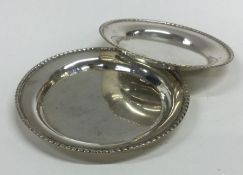 A graduated pair of circular silver dishes with be