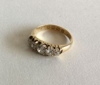 A diamond five stone half hoop ring in 18 carat go