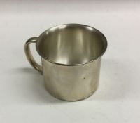 An unusual silver christening mug mounted with a r