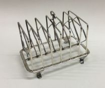 A large George III silver toast rack on tapering s