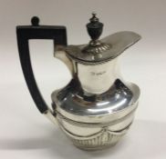 A heavy Victorian silver jug of half fluted design