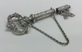A heavy silver needle case in the form of a key em
