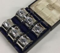 A good set of six silver napkin rings with swag de