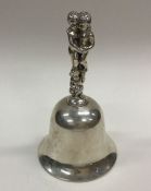 A heavy stylish silver bell decorated with childre