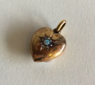 An attractive opal and diamond heart shaped pendan