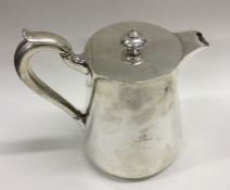 A heavy silver coffee pot with crested side. Londo