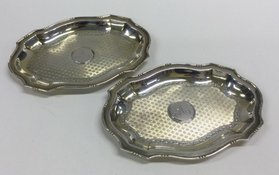 A pair of good quality silver engine turned dishes