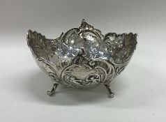 A heavy silver bonbon dish decorated with cherubs.