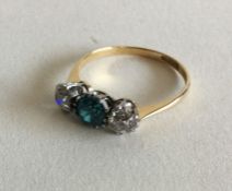 A diamond and zircon three stone ring in two colou