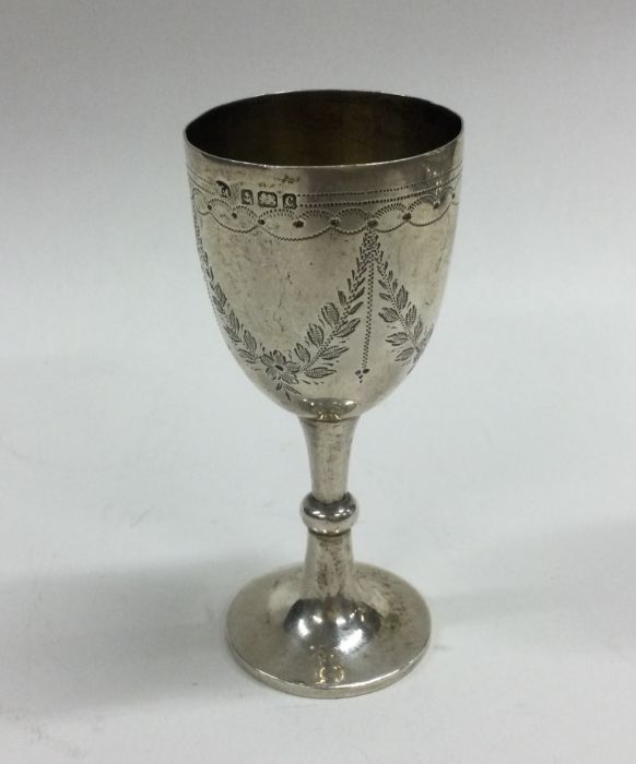 An engraved silver goblet with swag decoration. Bi