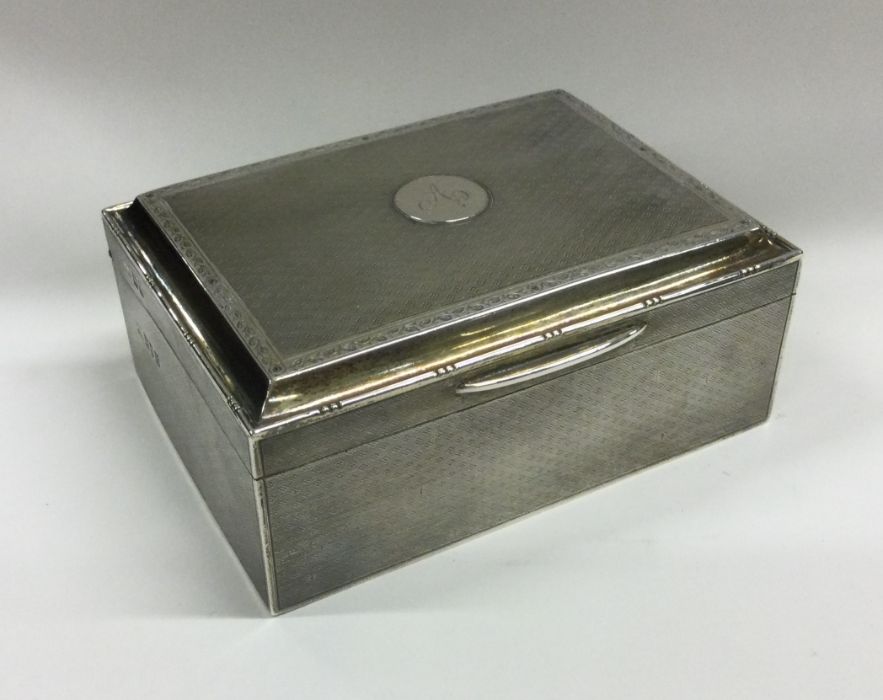 A good quality engine turned silver cigar case wit