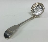 A George III silver sifter spoon with crested armo