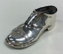 A large silver pin cushion in the form of a shoe w