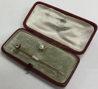 A small diamond single stone stick pin contained w