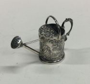 A novelty miniature silver watering can decorated