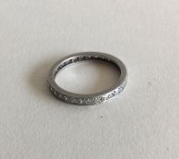 A diamond full eternity ring in platinum setting.