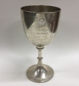 A heavy silver engraved goblet with swag decoratio