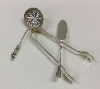 A pair of silver sugar tongs together with a sifte