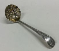 A heavy OE pattern silver sifter spoon with gilt b